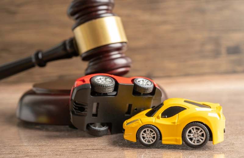 a toy cars next to a gavel