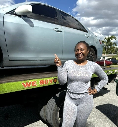 a person standing next to a car