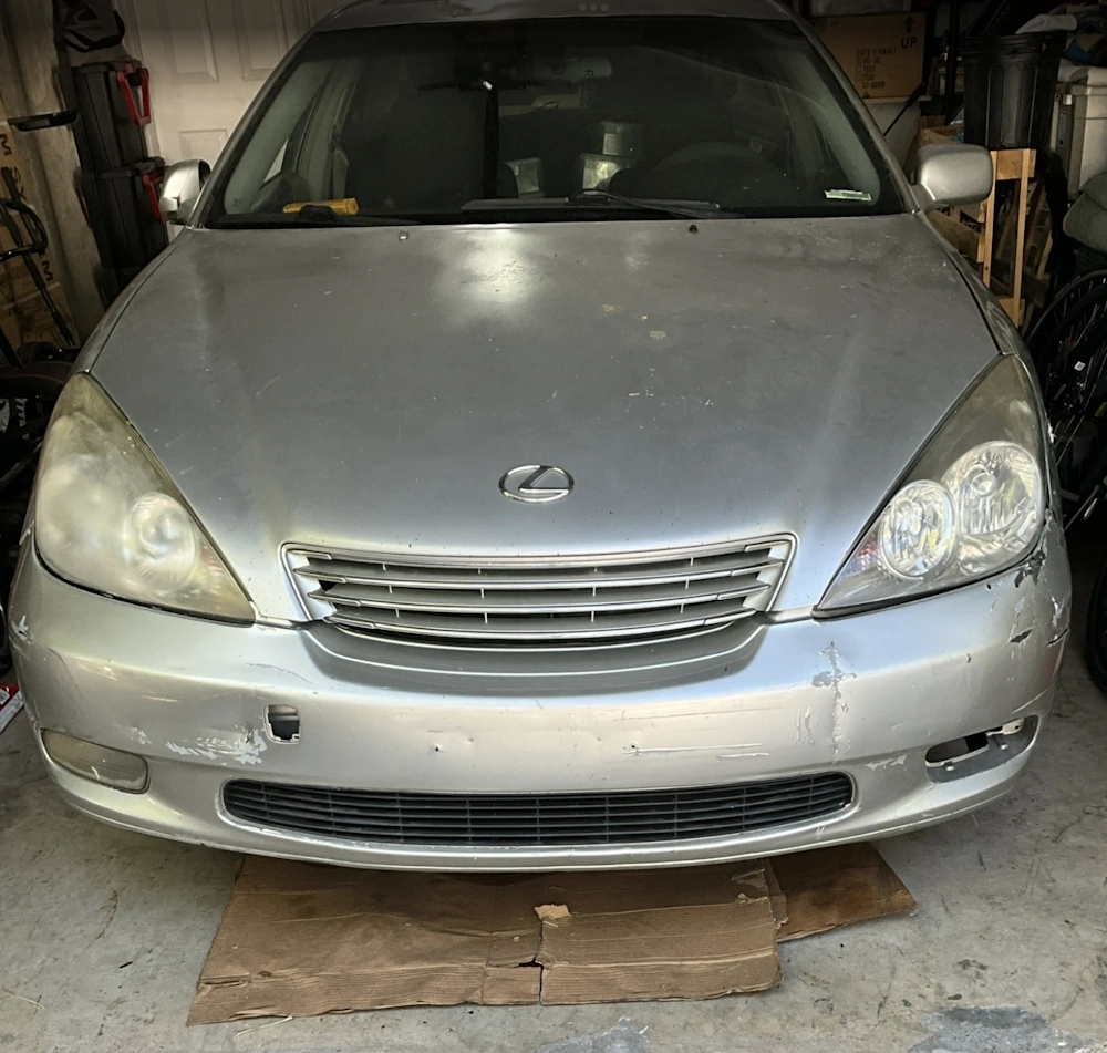 Lexus front view of with visible wear, parked inside Car buyer in Hialeah, FL garage