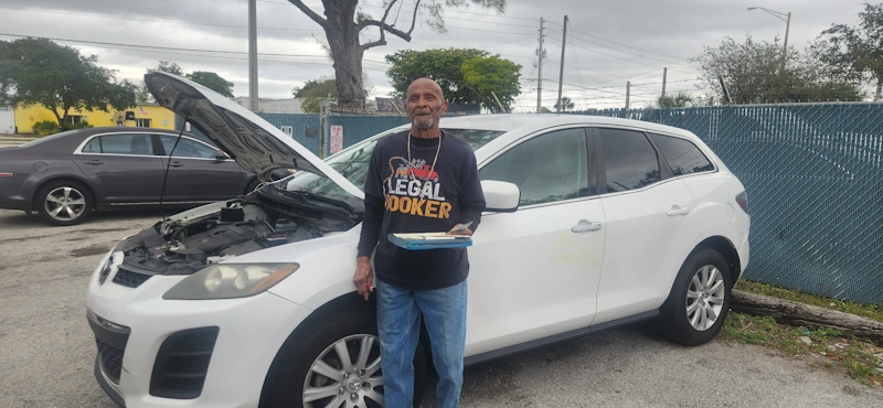Happy customer receiving cash for junk cars top dollar in Oakland Park from Junk Car Dog.