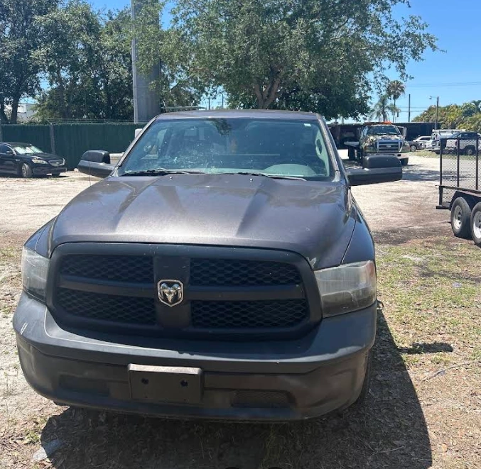 Front view of a gray Dodge Ram pickup truck being evaluated by a junk car buyer in South Florida